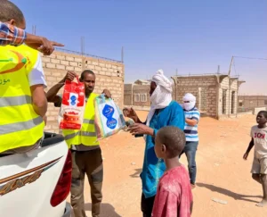 Moov Mauritel Ramadan lance une distribution de denrées alimentaires au profit des familles vulnérables pendant le Ramadan 4 Bénéficiaires recevant des sacs alimentaires de Moov Mauritel dans un quartier de Nouakchott pendant le Ramadan